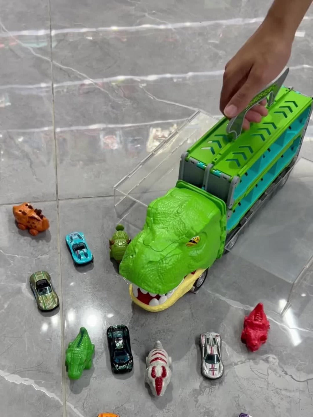 Dinosaur Truck Toys 13-in-1 Transport Carrier with 63-Inch Foldable Race Track, 6 Dino Cars + 6 Die-Cast Cars